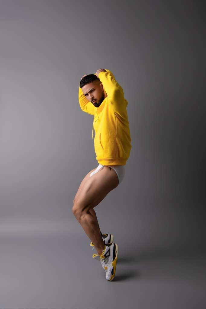 muscular-man-yellow-hoodie-white-shorts